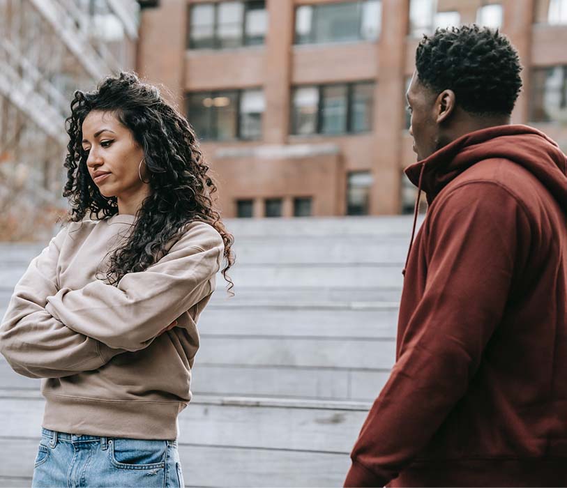 A couple arguing each other in city