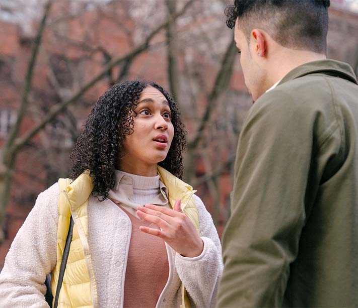 A couple arguing on street in daytime