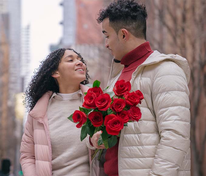 A couple with bunch of red roses