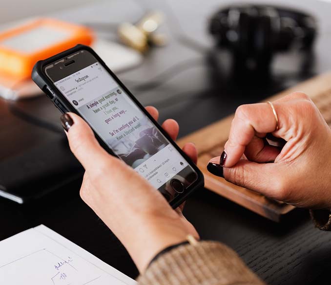 A crop woman using smartphone sitting the at table