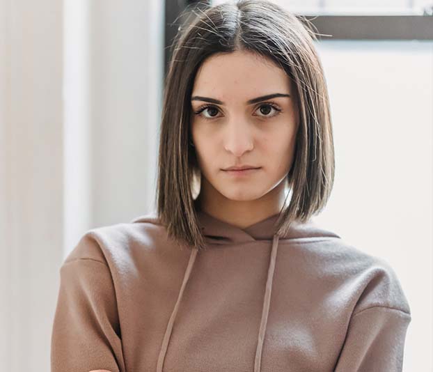 A displeased woman standing in a room