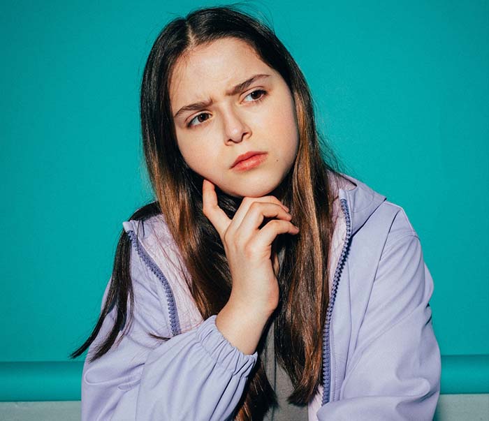 A girl wearing a jacket thinking