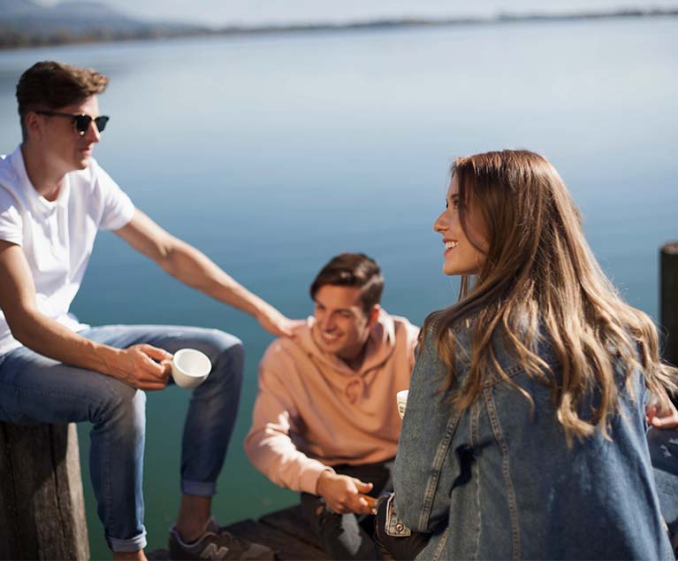 A group of people sitting on boat dock