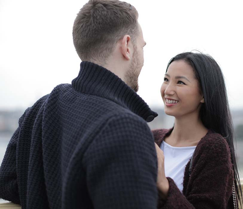 A happy couple standing near buildings