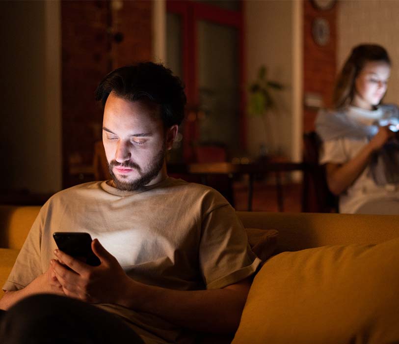 A man and a woman chatting to each other on an apple iphone