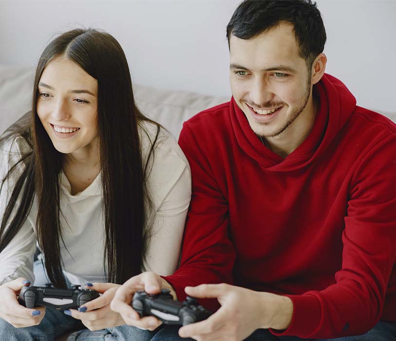A man and a woman laughing while playing games