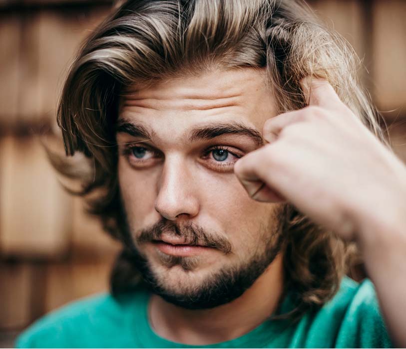 A man in a green crew neck shirt