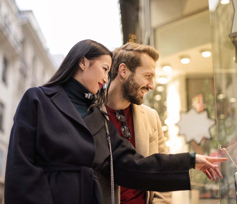 A man in brown coat standing beside a woman in a black coat