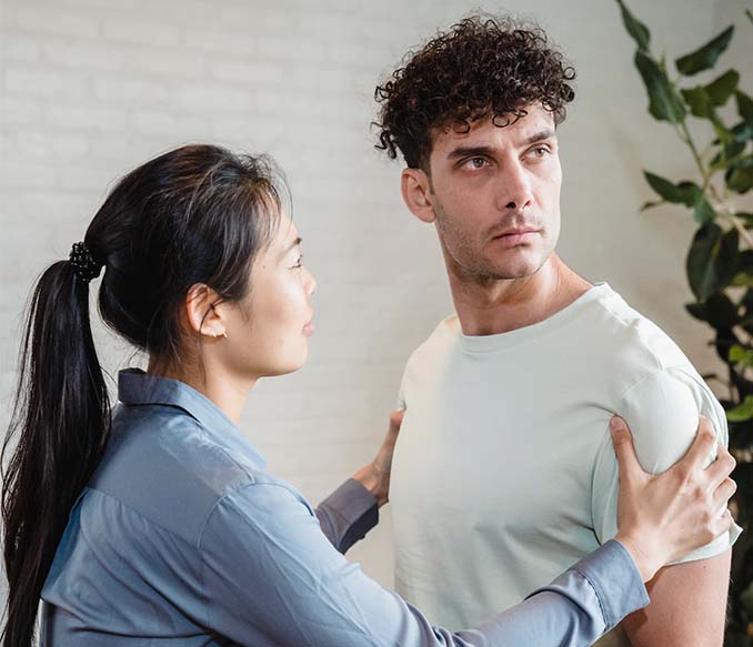 A man looking away while the woman is talking to him