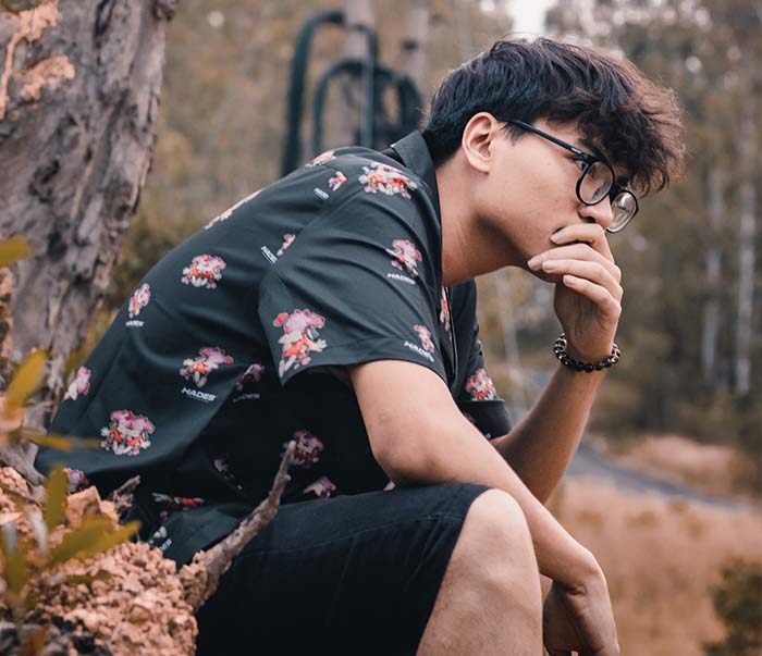 A man wearing floral polo dress shirt