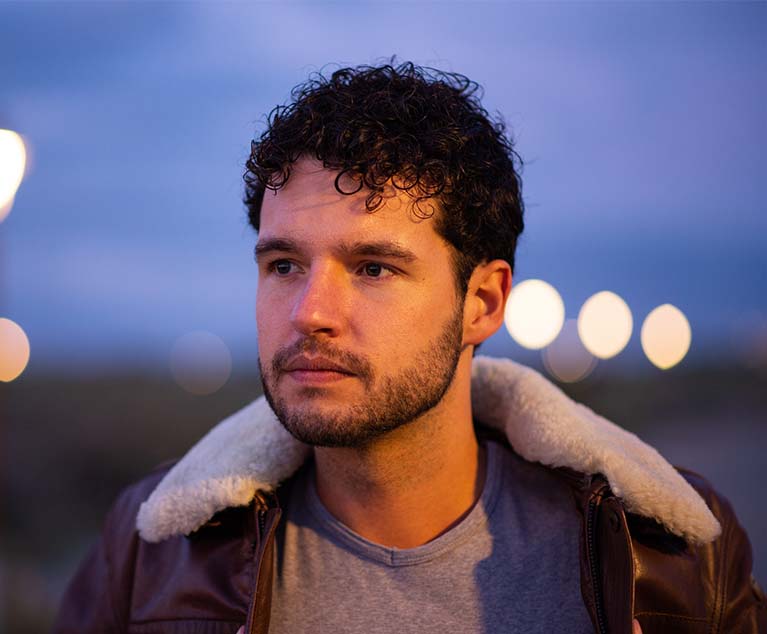 A portrait of a man wearing a black leather jacket