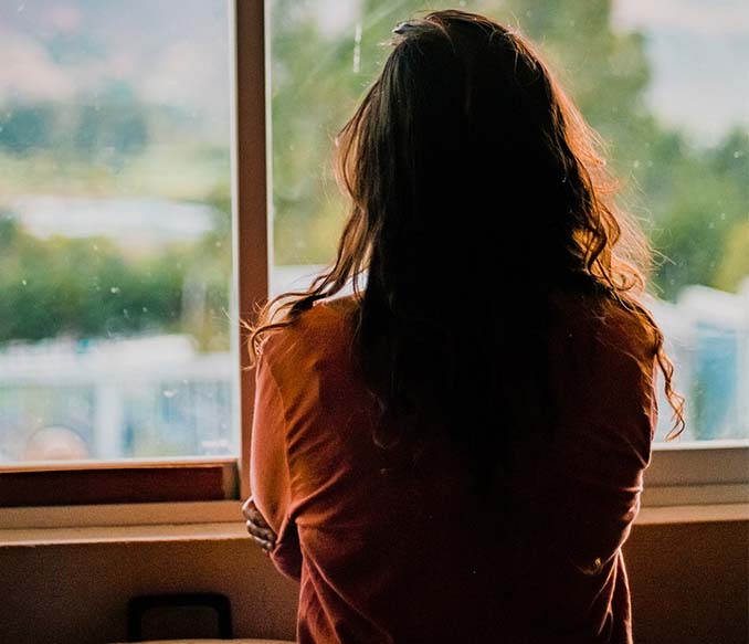 A woman wearing brown shirt inside room