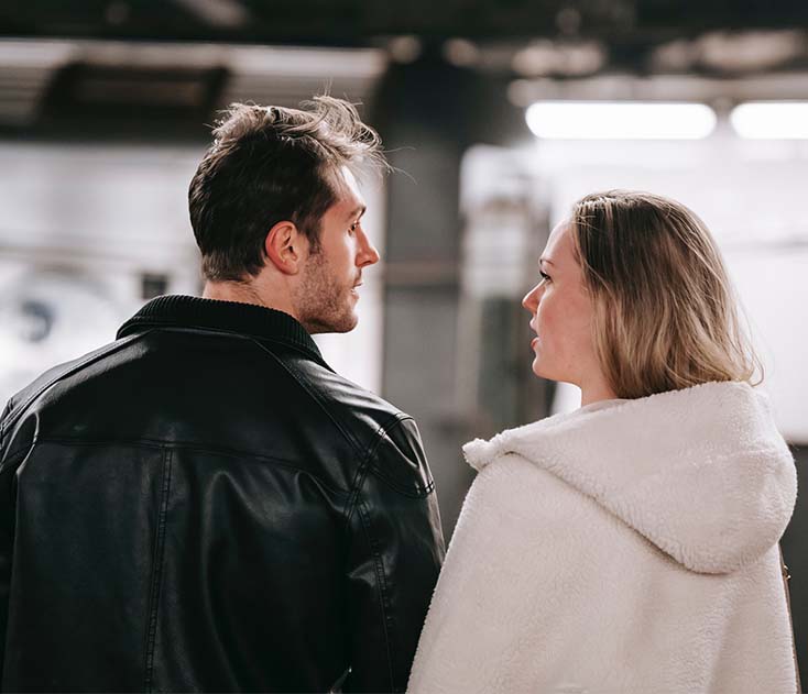 A young couple standing together in metro