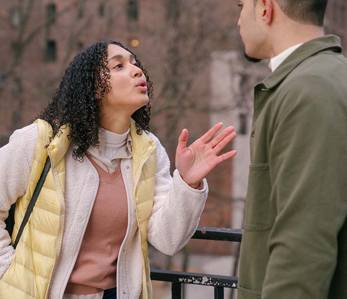 A young ethnic couple arguing on street