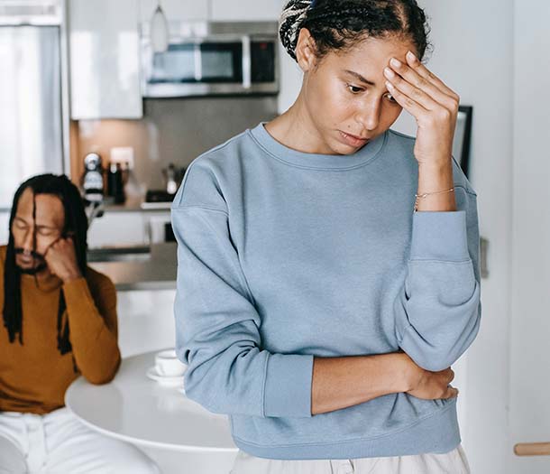 Black couple arguing with each other in kitchen