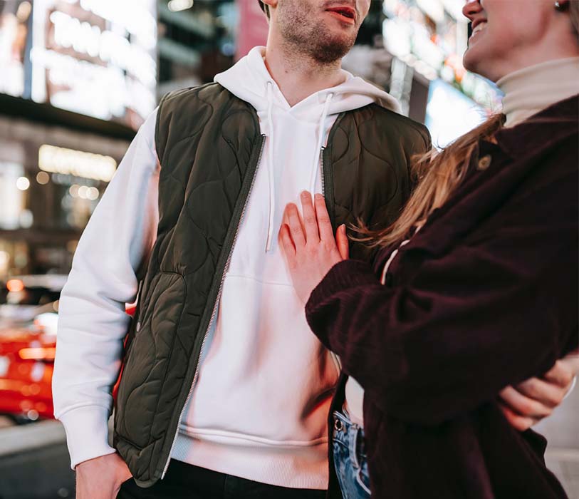 Crop couple hugging in a street