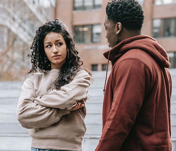 Disappointed multiethnic couple having argument on street