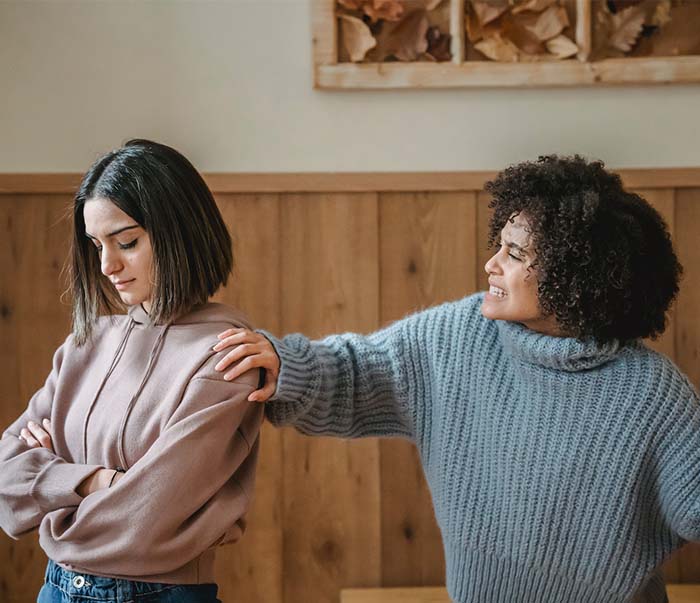 Two ladies having disagreement in room