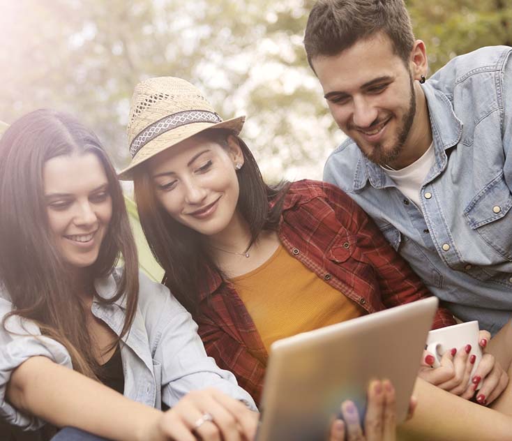 cheerful woman showing friends funny video on tablet