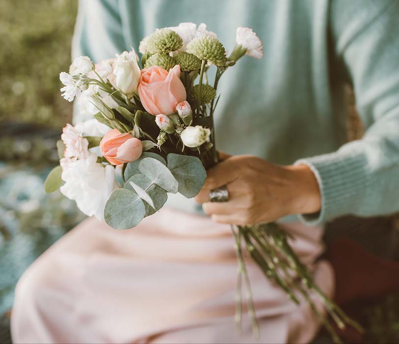 close up shot of a person holding flowers