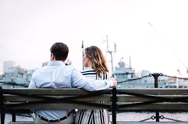 A girl and a boy are sitting on a chair.