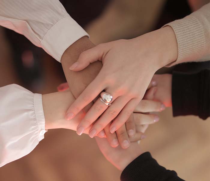 crop-friends-stacking-hands-togethe