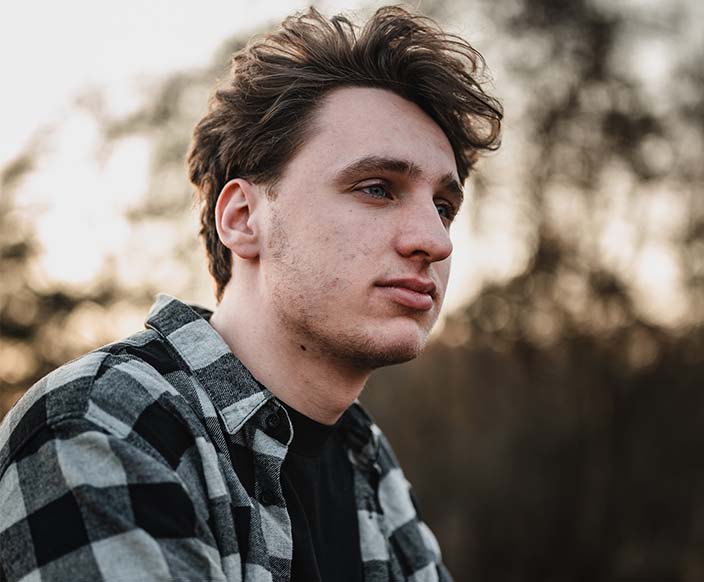 A man in a white and black plaid dress shirt