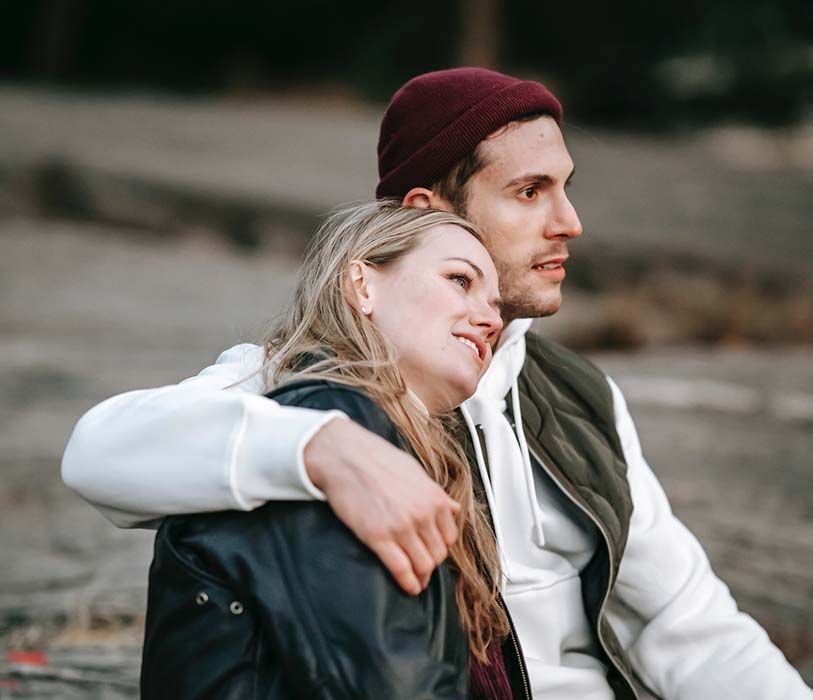 loving couple hugging while sitting on ground