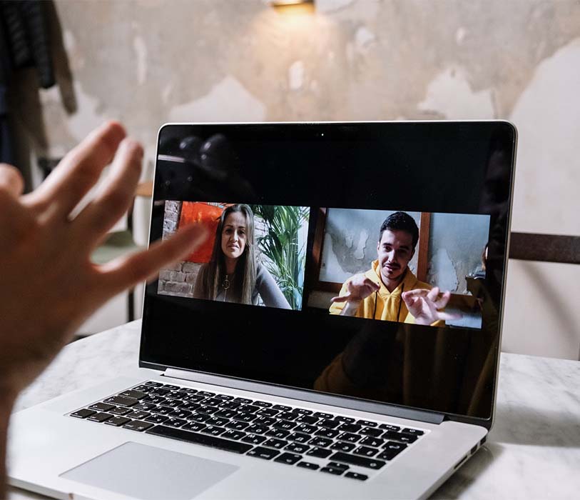 man and woman video call on laptop