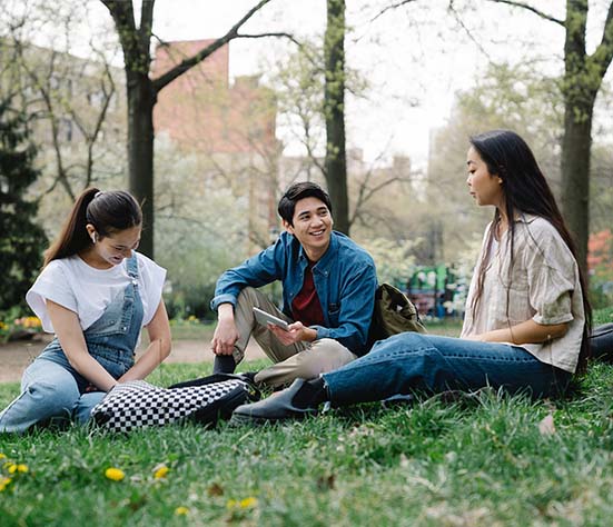 photo of a group of friends sitting on the grass