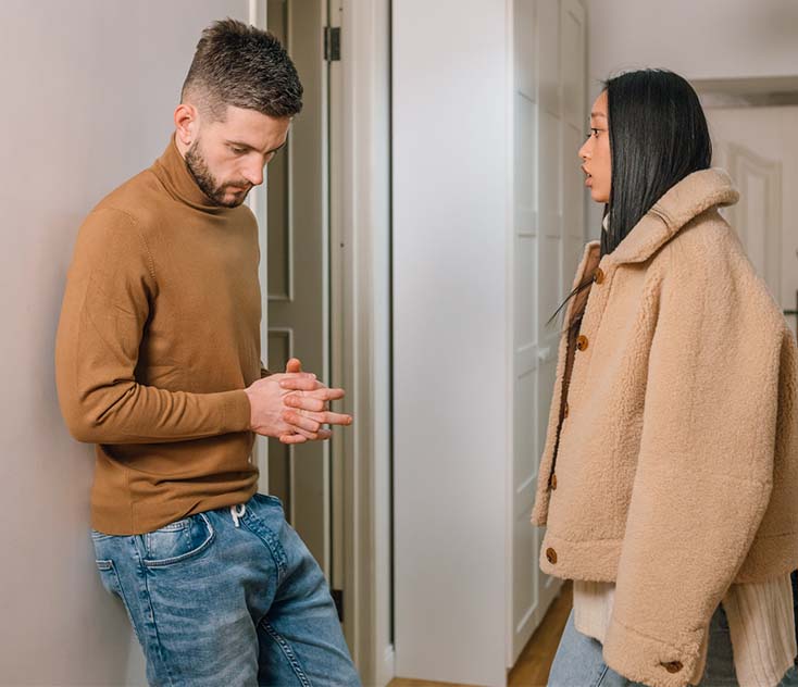 photo of a woman talking to a man in a brown shirt