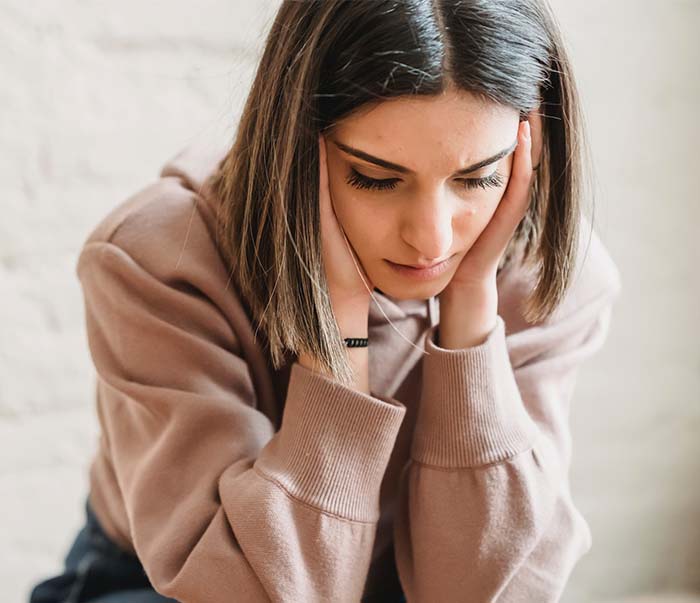 sad woman sitting in room