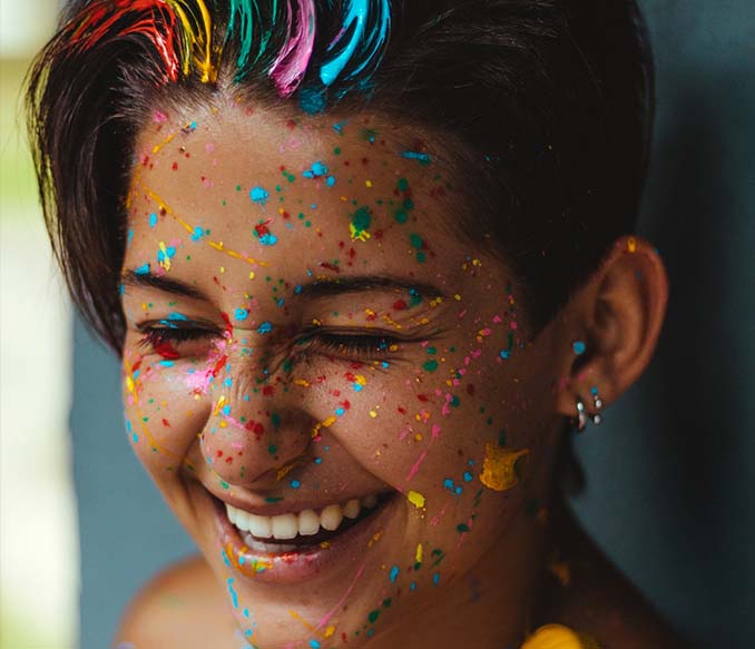 shallow focus photo of man smiling with face paints