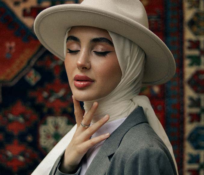 woman posing in beige fedora hat headscarf and grey blazer