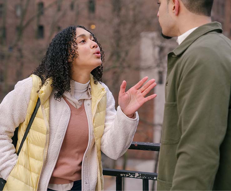 A man and a woman arguing to each other on street